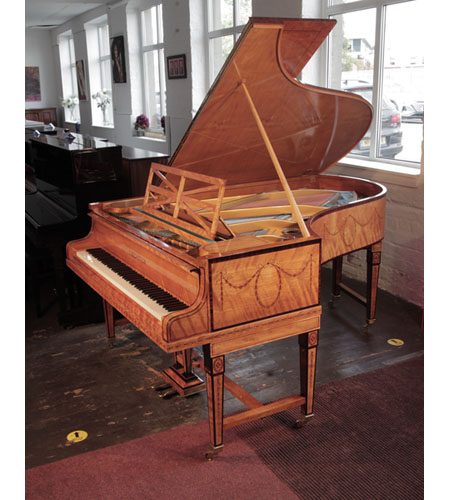 Bechstein Model B grand piano with a book-matched, satinwood case with boxwood stringing. Piano has gate legs attached with a cross stretcher. Entire cabinet inlaid with swagged bellflowers and bows.