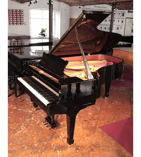 A 2008, Steinway Model B grand piano for sale with a black case and spade legs
