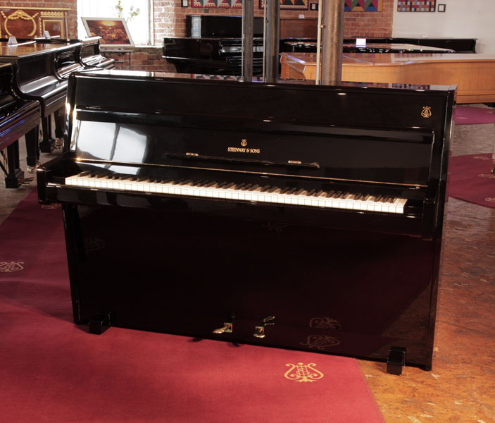 Reconditioned, 1960, Steinway Model F  upright piano for sale with a black case and brass fittings. Piano has an eighty-eight note keyboard and two pedals