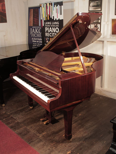 Reconditioned, 1972, Yamaha G2 grand piano with a mahogany case and spade legs. Piano has an eighty-eight note keyboard and a three-pedal lyre.  