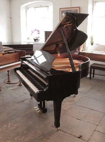 Carl Steinberg baby  grand piano with a black case and brass fittings. Piano has an eighty-eight note keyboard and three-pedal lyre. A German designed, affordable baby grand made in China