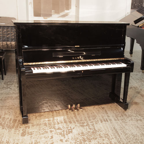 Piano for sale. Reconditioned, 1987, Kawai BS-20  upright piano with a black case and polyester finish. Piano has an eighty-eight note keyboard and three pedals. 