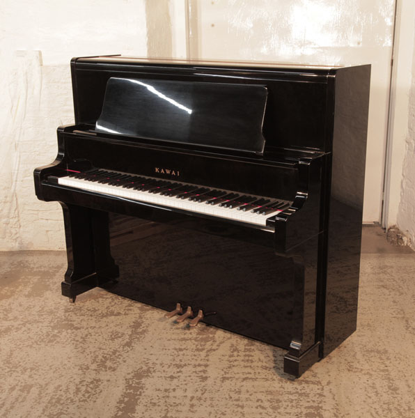 Reconditioned, 1982, Kawai  US-50  upright piano for sale with a black gloss case. Piano has an eighty-eight note keyboard and three pedals.  