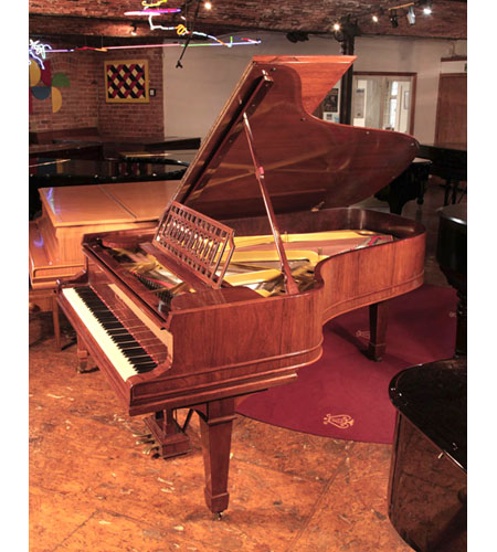 Restored, 1911, Steinway Model B grand piano for sale with a rosewood case and spade legs.  Music desk is in an openwork design of interlocking ovals. Piano has an eighty-eight note keyboard and a three-pedal lyre. 