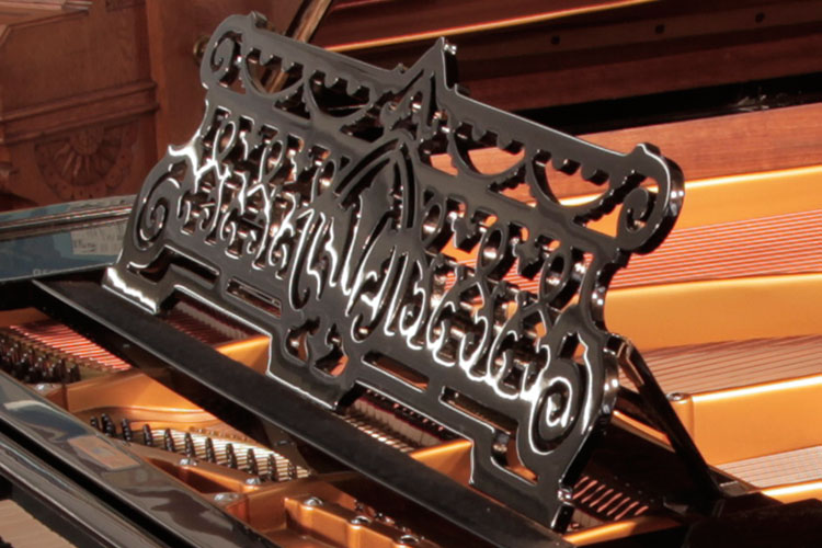 Bechstein Model V openwork music desk in a scrolling arabesque design with swags and a central anthemion motif