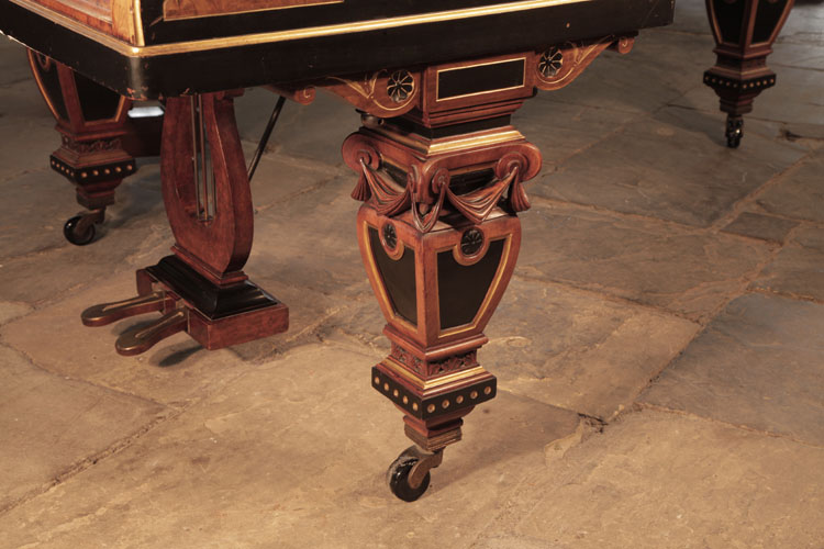 Erard four sided baluster piano leg in black, gold and walnut with carved swagged fabric, patera and lotus embellishment. The pediment features two black paterae with stylised gold hibiscus.