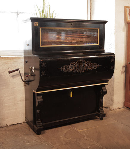 Frederick Gray & Co Barrell Piano. Cabinet features etched decoration on fall. There is a slot to take old pennies for operation. The cabinet features a glass front panel which allows the action to be visible. 