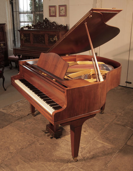 Reconditioned,  1970,  Welmar baby grand piano for sale with a mahogany case and square, tapered legs. Piano has an eighty-eight note keyboard and a two-pedal lyre. 