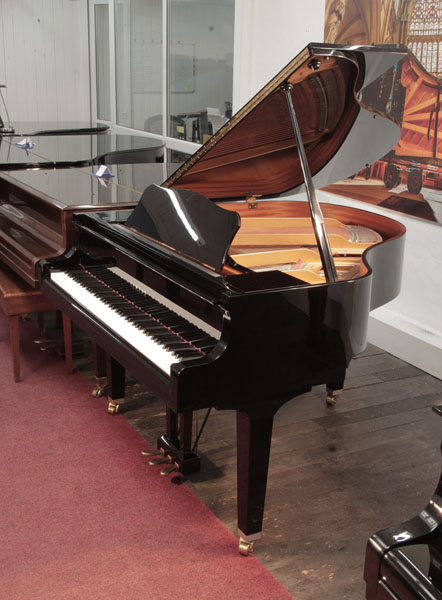  A 2001, Yamaha GA1 baby  grand piano for sale with a black case and square, tapered legs. Condition as new. Piano has an eighty-eight note keyboard and a three-pedal lyre. 