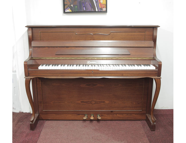  Dietmann upright piano with a walnut case and cabriole legs. Piano has an eighty-eight note keyboard and three pedals
