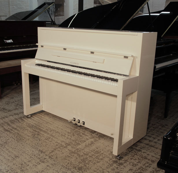 Bauhaus style, Feurich Model 115 Premiere upright piano in white gloss with chrome fittings.  Piano has an eighty-eight note keyboard and three pedals. 
