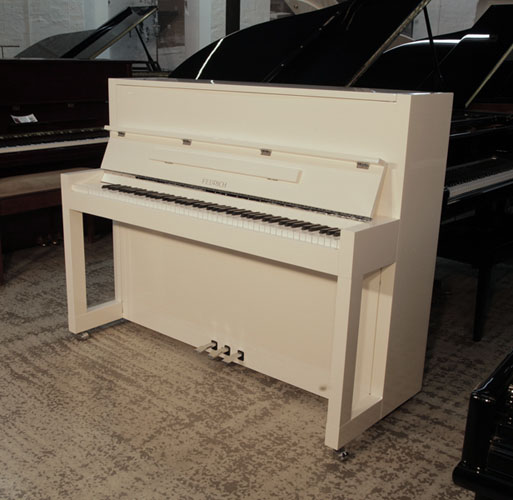 RBauhaus style, Feurich Model 115 Premiere upright piano with a white gloss case with chrome fittings. A stylish, small size piano to fit the modern home.. Piano has an eighty-eight note keyboard and  three pedals
