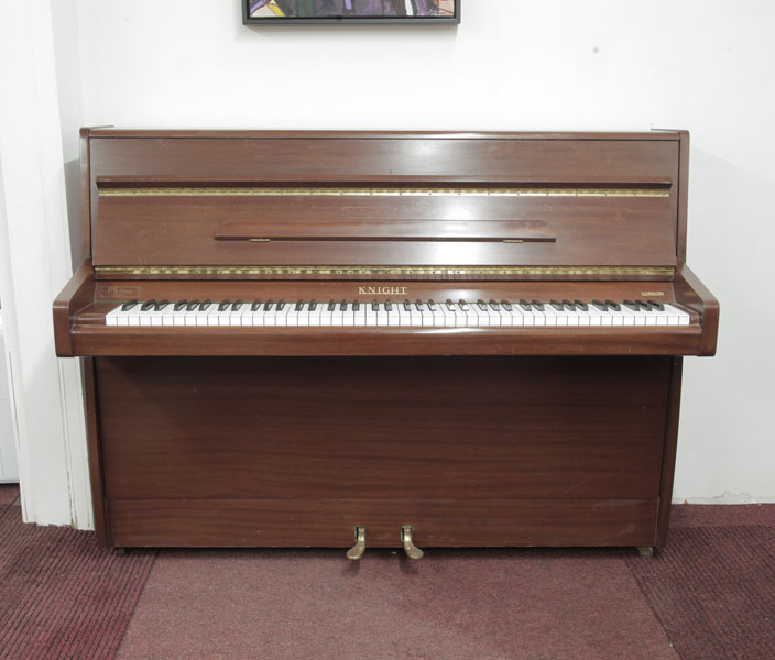 Pre-owned, 1970, Knight upright piano with a mahogany case . Piano has an eighty-eight note keyboard and two pedals.