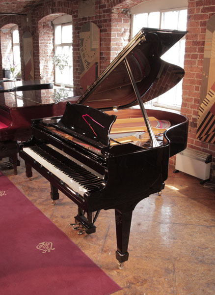 Reconditioned, 1996, Steinway Model M grand piano for sale with a black case and spade legs. Piano has an eighty-eight note keyboard and a three-pedal lyre. 