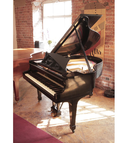 A 1925, Steinway Model S baby grand piano for sale with a black case and spade legs. Piano has an eighty-eight note keyboard and a two-pedal lyre. 