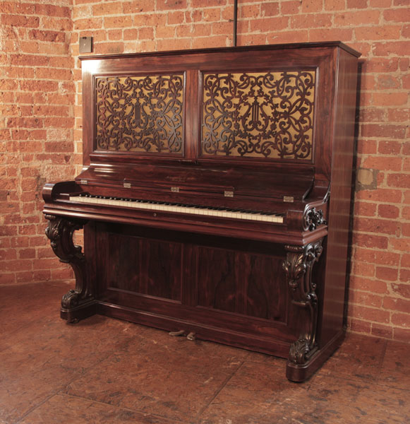 An 1862, Steinway  upright piano for sale with a polished, rosewood case carved, reverse scroll legs. Cabinet features openwork panels in an arabesque design. Exquisite antique styling. Piano has eighty-five notes and two pedals. 