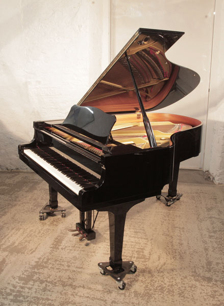 Reconditioned,  1988, Yamaha C3 grand piano for sale with a black gloss and spade legs. Piano has an eighty-eight note keyboard and a three-pedal lyre. 