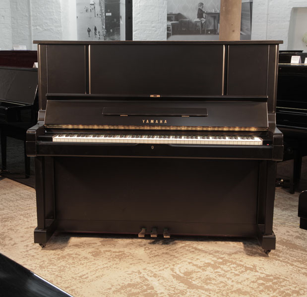 Reconditioned, 1981, Yamaha YUX upright piano for sale with a satin, black case and brass fittings. Piano has an eighty-eight note keyboard and three pedals. 
 