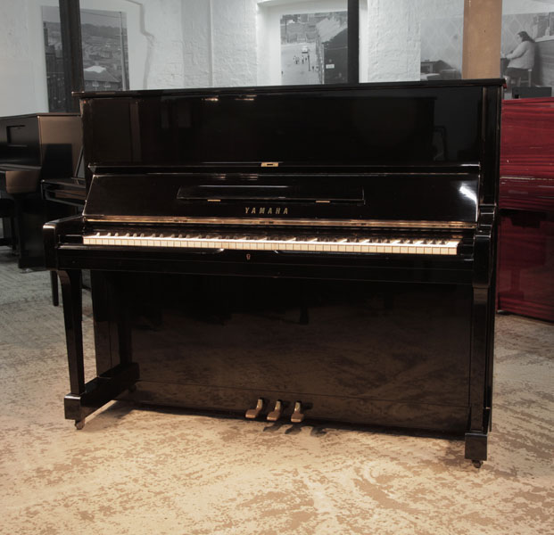 Reconditioned, 1973, Yamaha U1 upright piano for sale with a black case and brass fittings. Piano has an eighty-eight note keyboard and three pedals.  