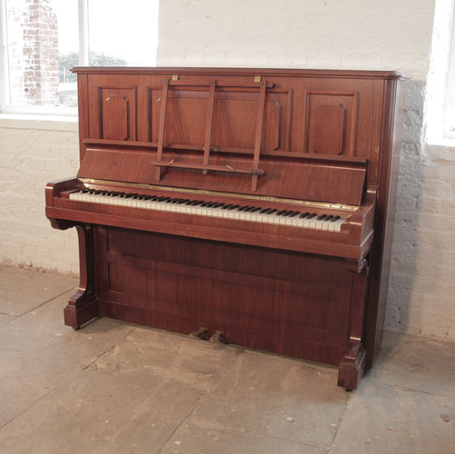 Reconditioned,  1923, Bechstein model 8 upright piano with a rosewood case and brass fittings. Piano has an eighty-eight note keyboard and two pedals. 