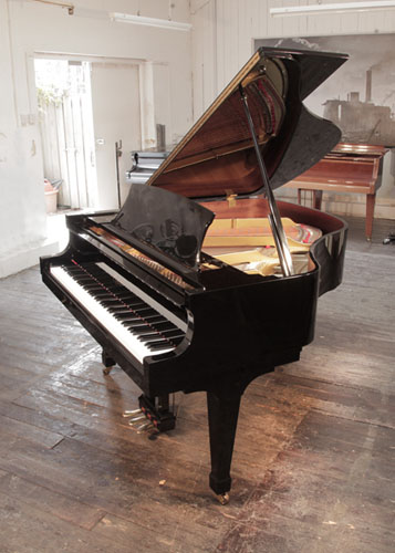 Reconditioned 1999, Boston GP156 II baby grand piano with a black gloss case and brass fittings. Designed by Steinway. Piano has an eighty-eight note keyboard and a three-pedal lyre. 