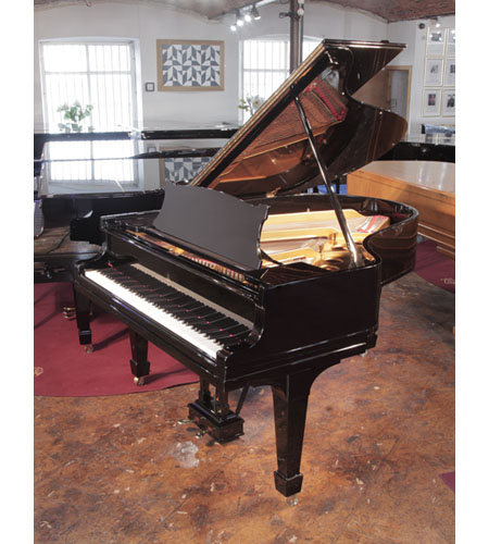 Rebuilt 1922, Steinway Model O grand piano has a black gloss case and brass fittings. Piano has an eighty-eight note keyboard and a two-pedal lyre. 