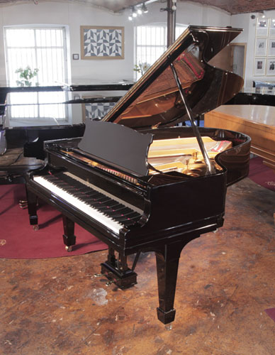 Rebuilt 1922, Steinway Model O grand piano has a black gloss case and brass fittings. Piano has an eighty-eight note keyboard and a two-pedal lyre.    