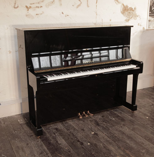  Reconditioned, 1994, Yamaha U1 upright piano with a black case and polyester finish. Piano has an eighty-eight note keyboard and three pedals. 
